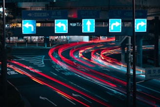 a city street filled with lots of traffic at night