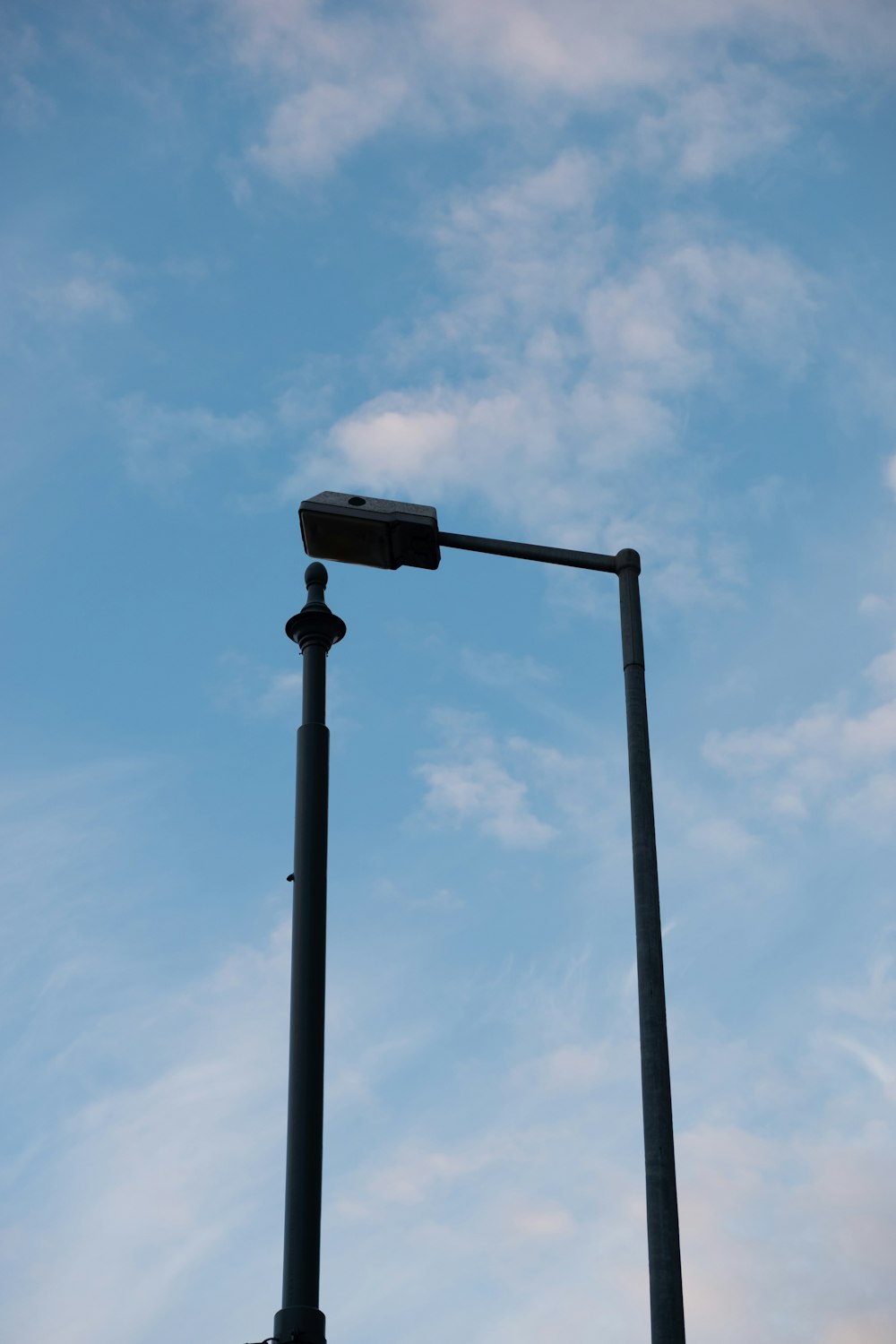 a street light with a blue sky in the background