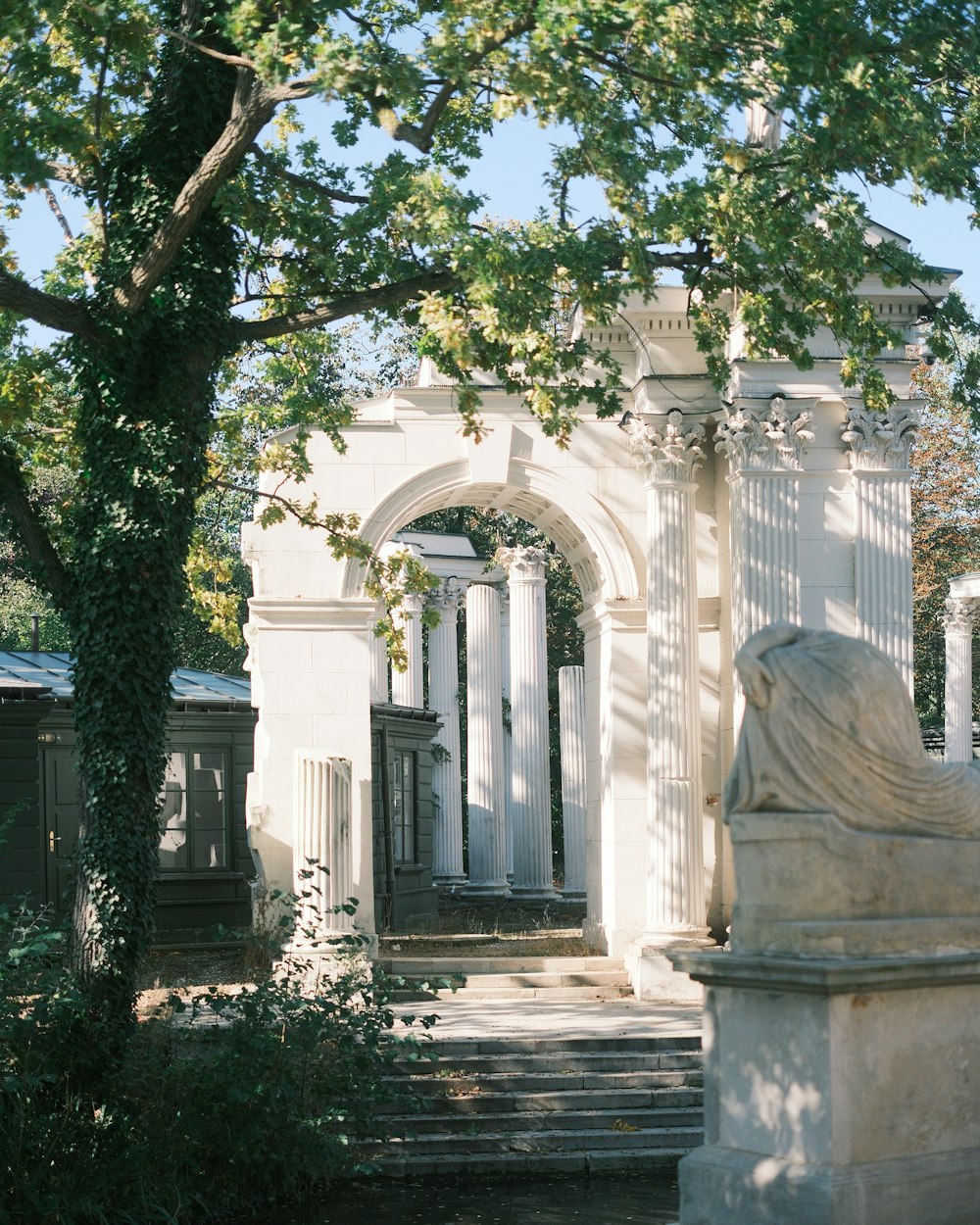 a white building with a statue in front of it