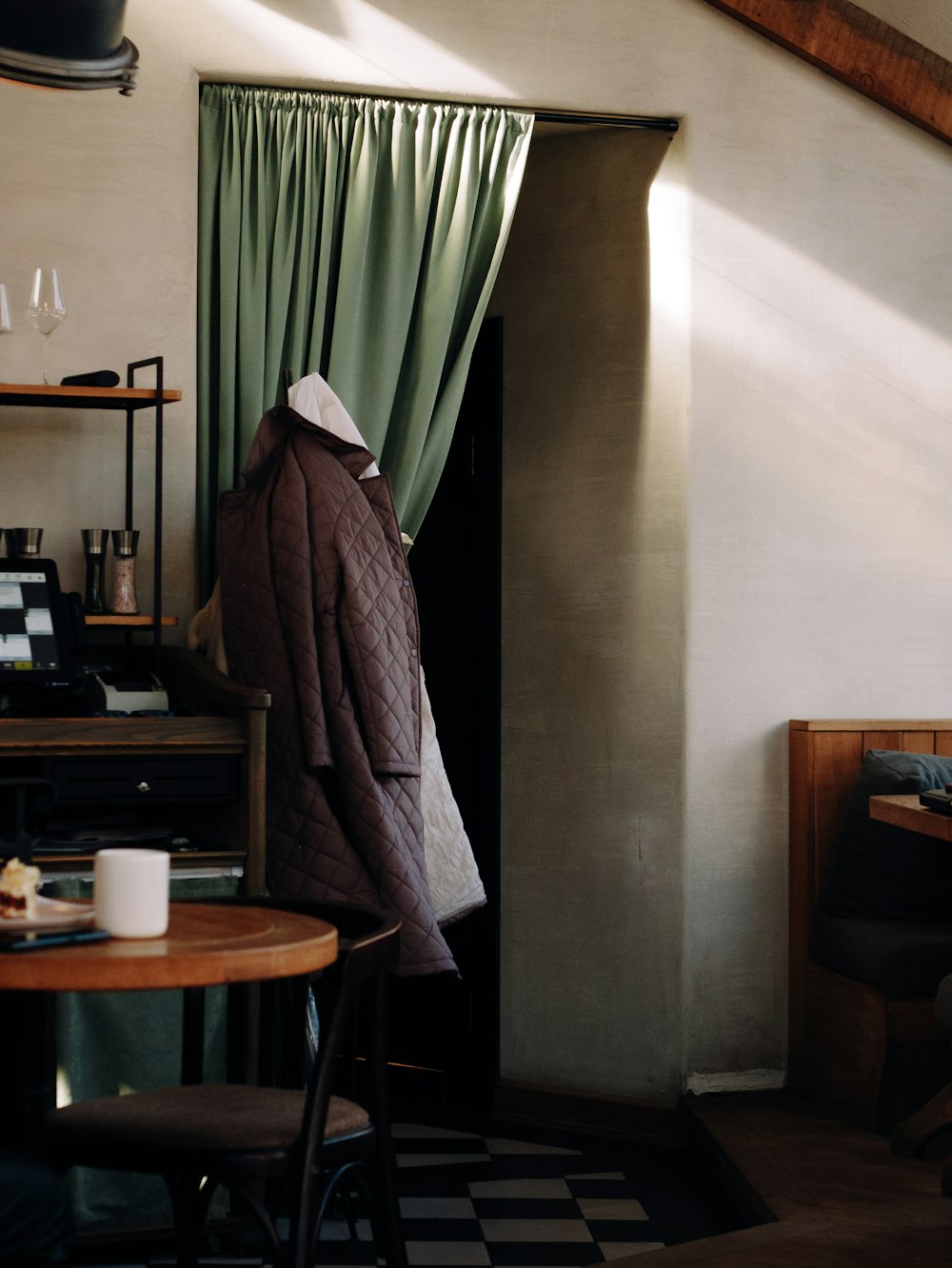 a coat hanging on a coat rack in a room