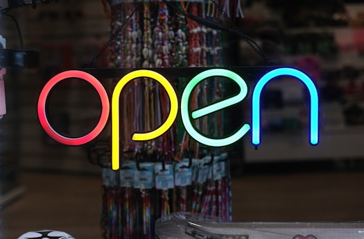 a neon sign that says open in a store