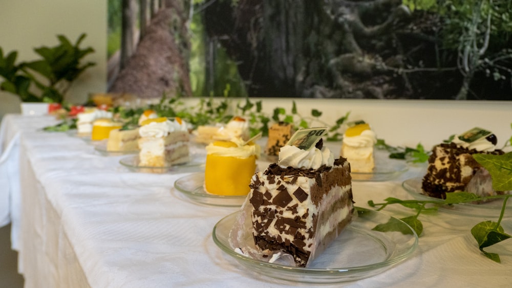 a table topped with cakes and desserts on top of plates