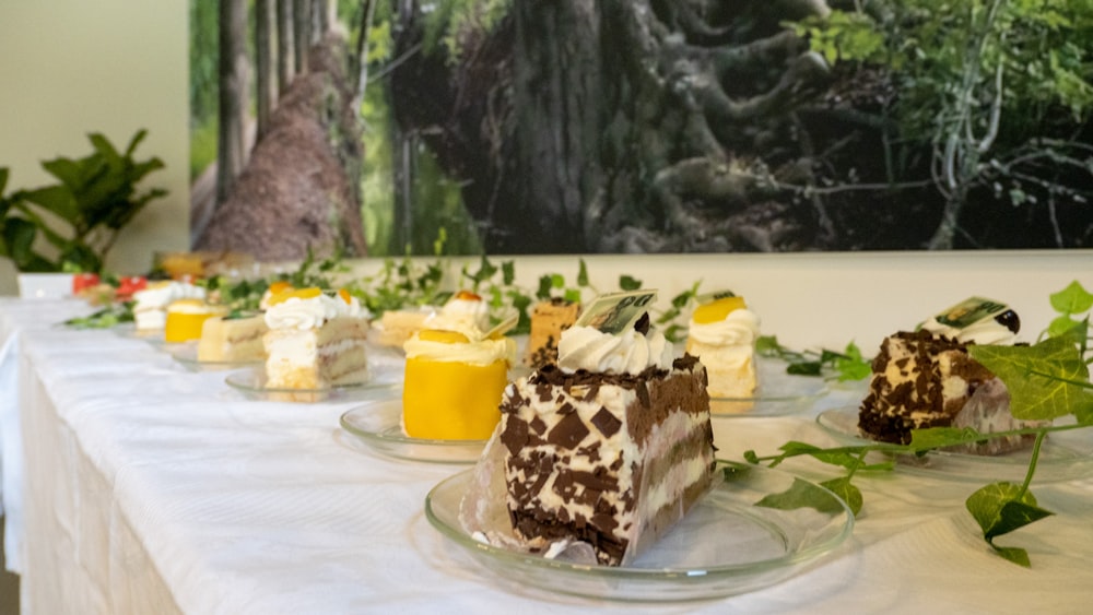 a table topped with cakes and desserts on top of plates