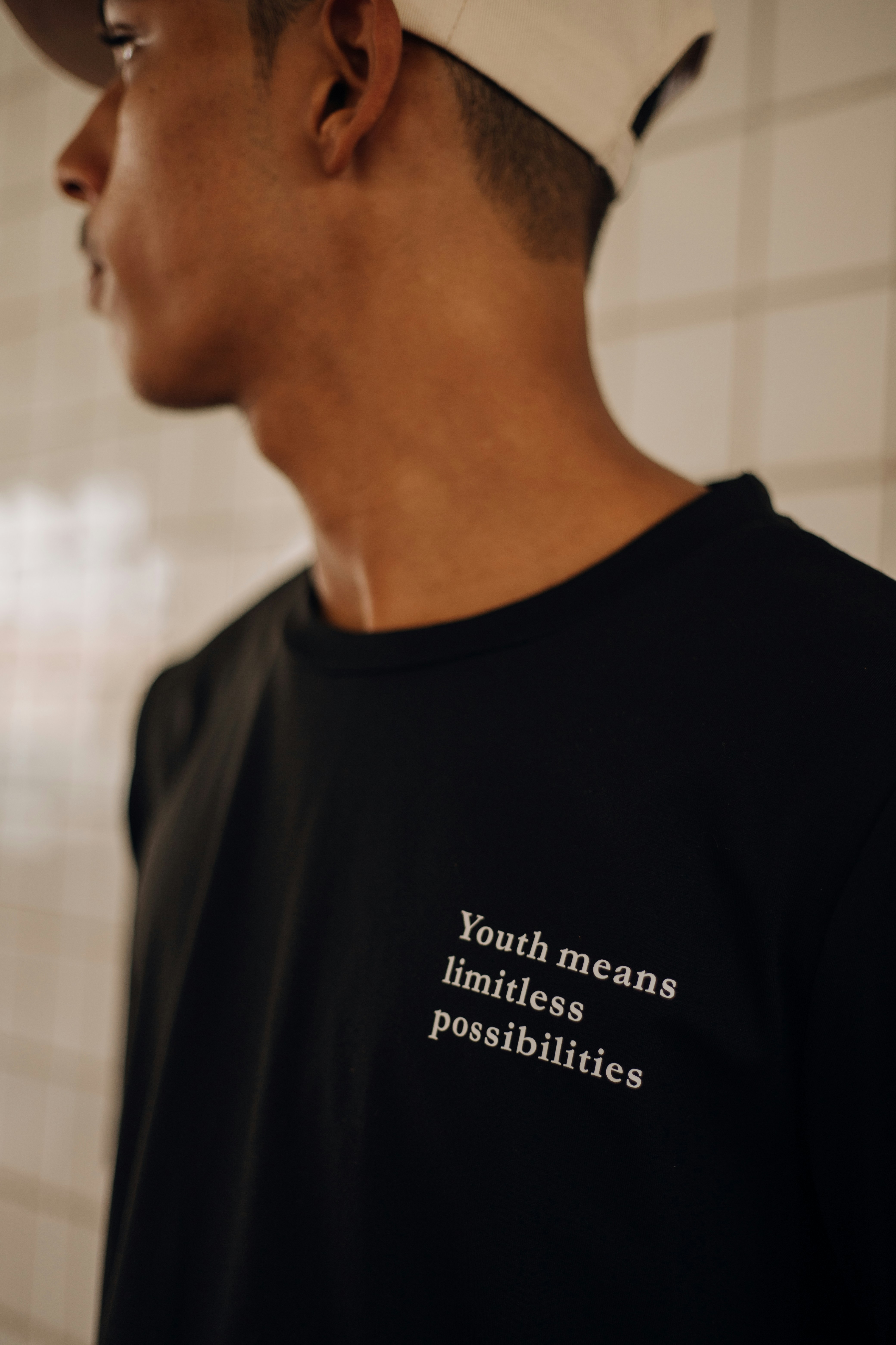 a man wearing a black shirt and a white hat