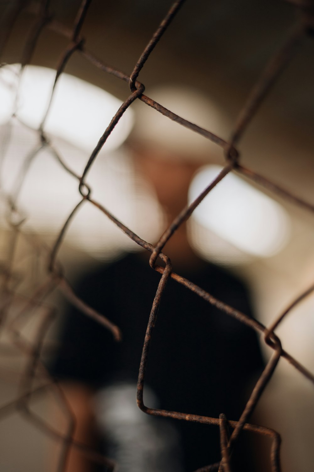 a blurry photo of a person behind a fence