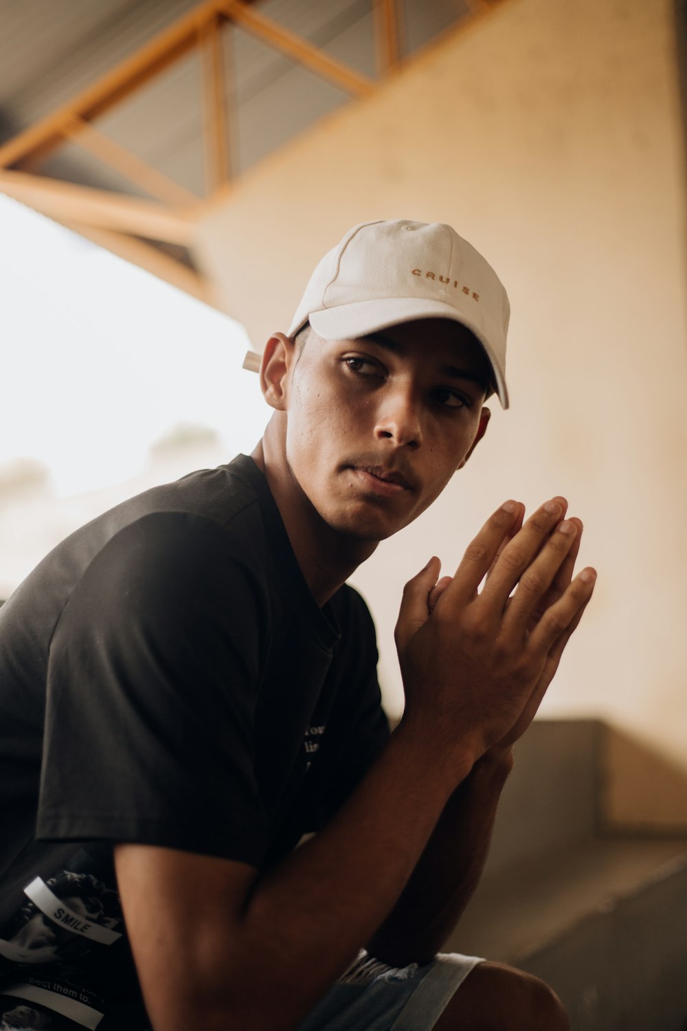 a man in a black shirt and a white hat