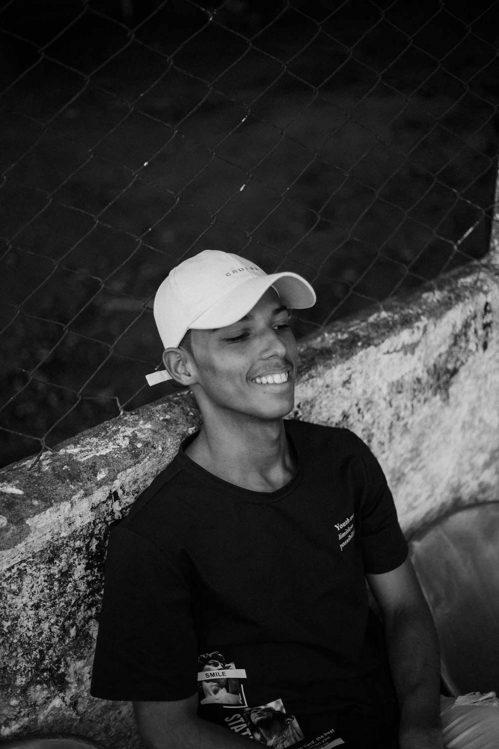 a black and white photo of a man wearing a hat