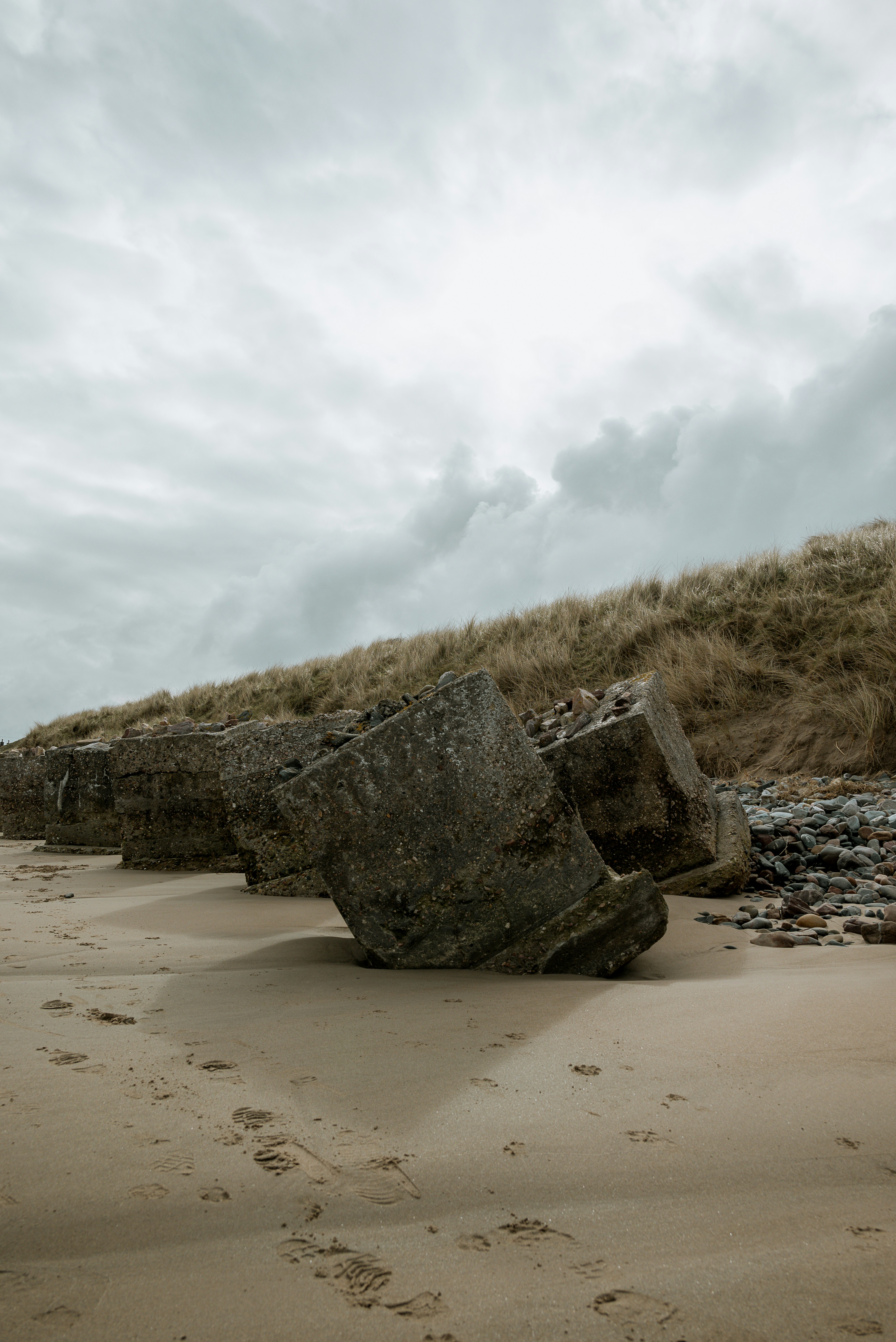 A large rock sitting on top of a sandy beach photo – Free Beach Image ...