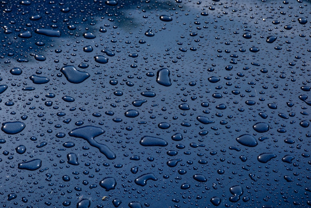 a close up of water droplets on a blue surface