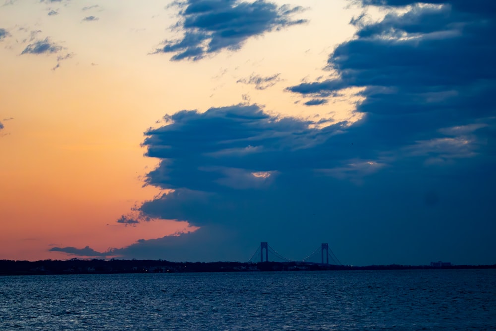 a large body of water under a cloudy sky