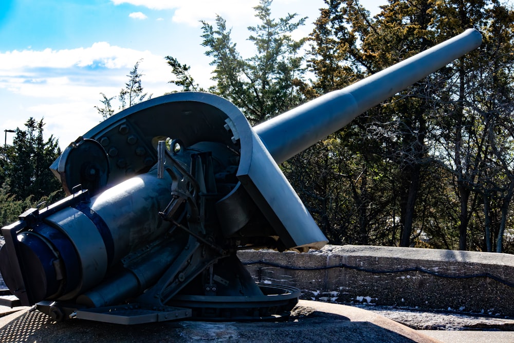 a large metal object sitting on top of a cement wall