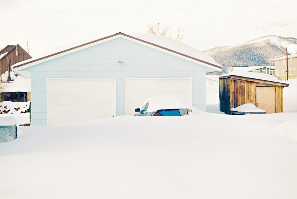 a snow covered yard with a car parked in the snow