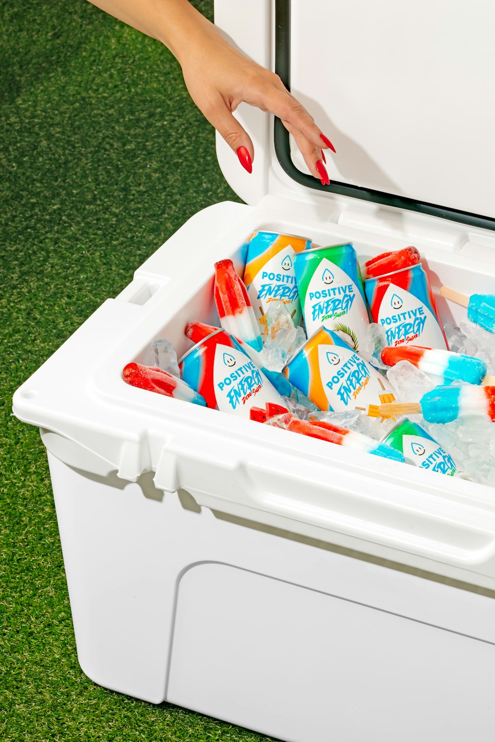 a woman putting a cooler full of drinks in it