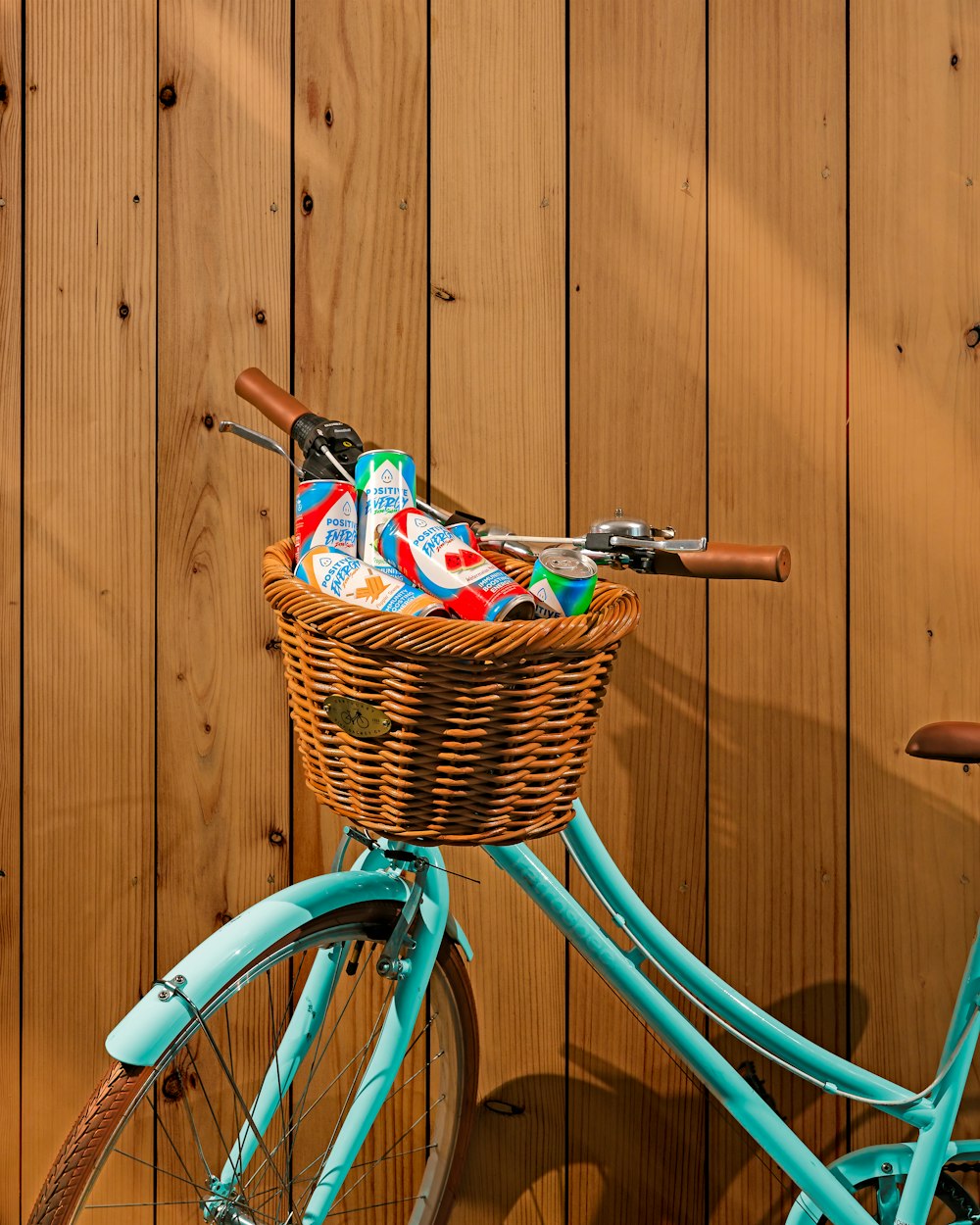 a blue bicycle with a basket full of items