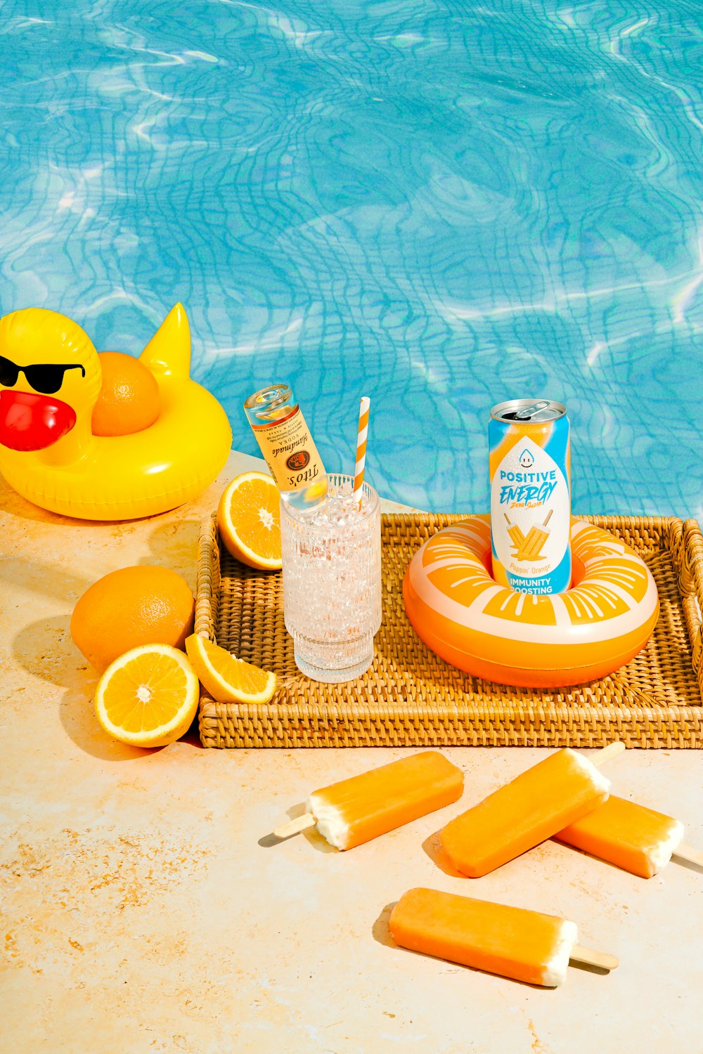 a tray of orange slices next to a swimming pool