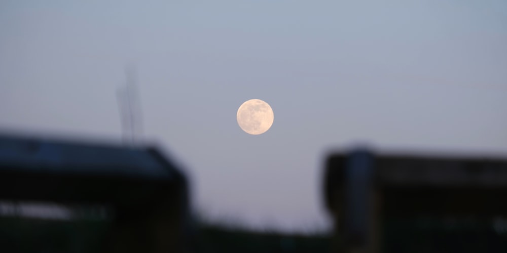 a view of a full moon from a distance