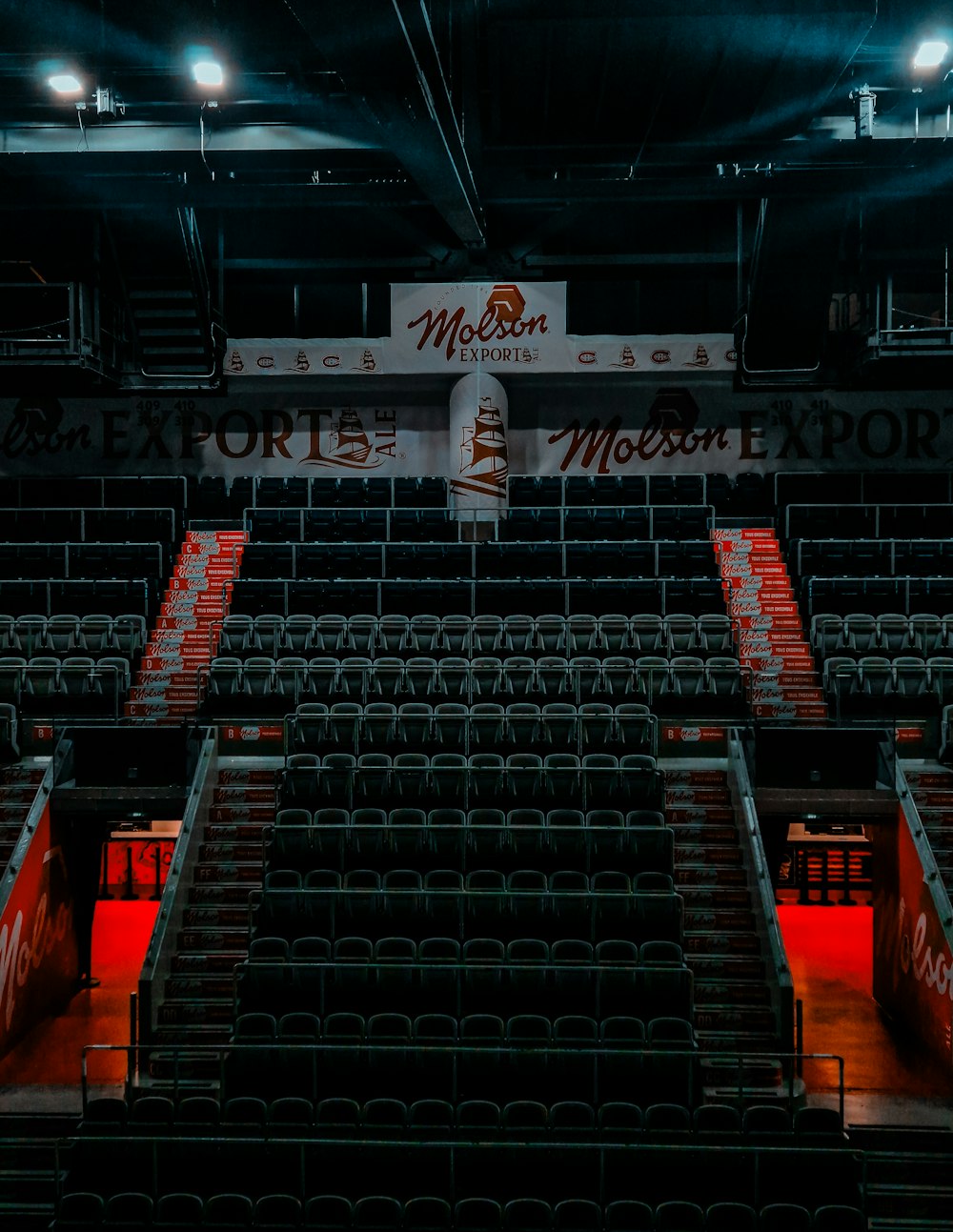 an empty stadium with seats and a sign on the wall