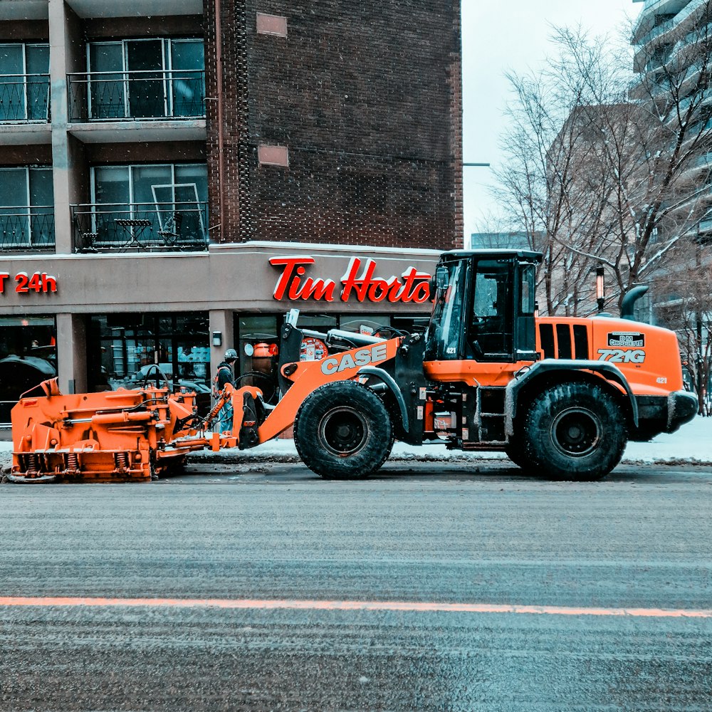 a tractor is parked in front of a store