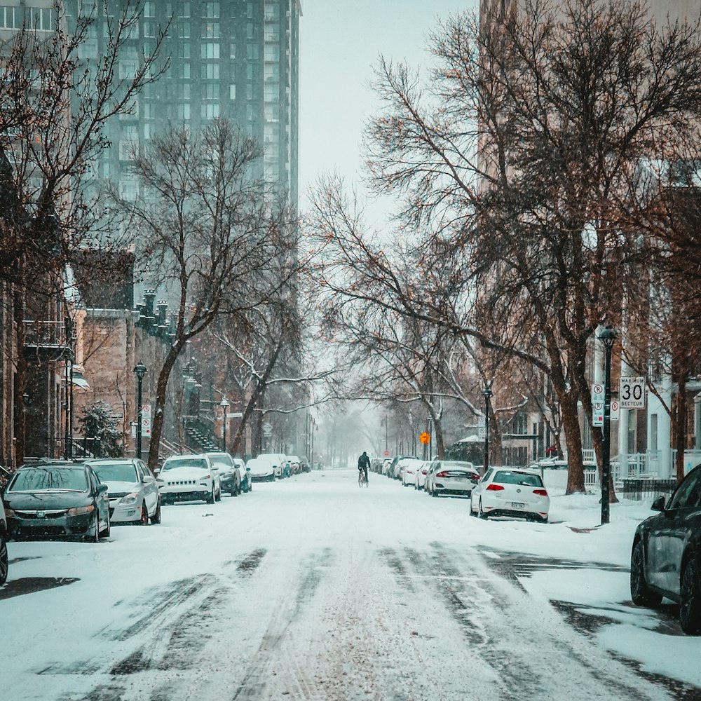 a person walking down a snow covered street