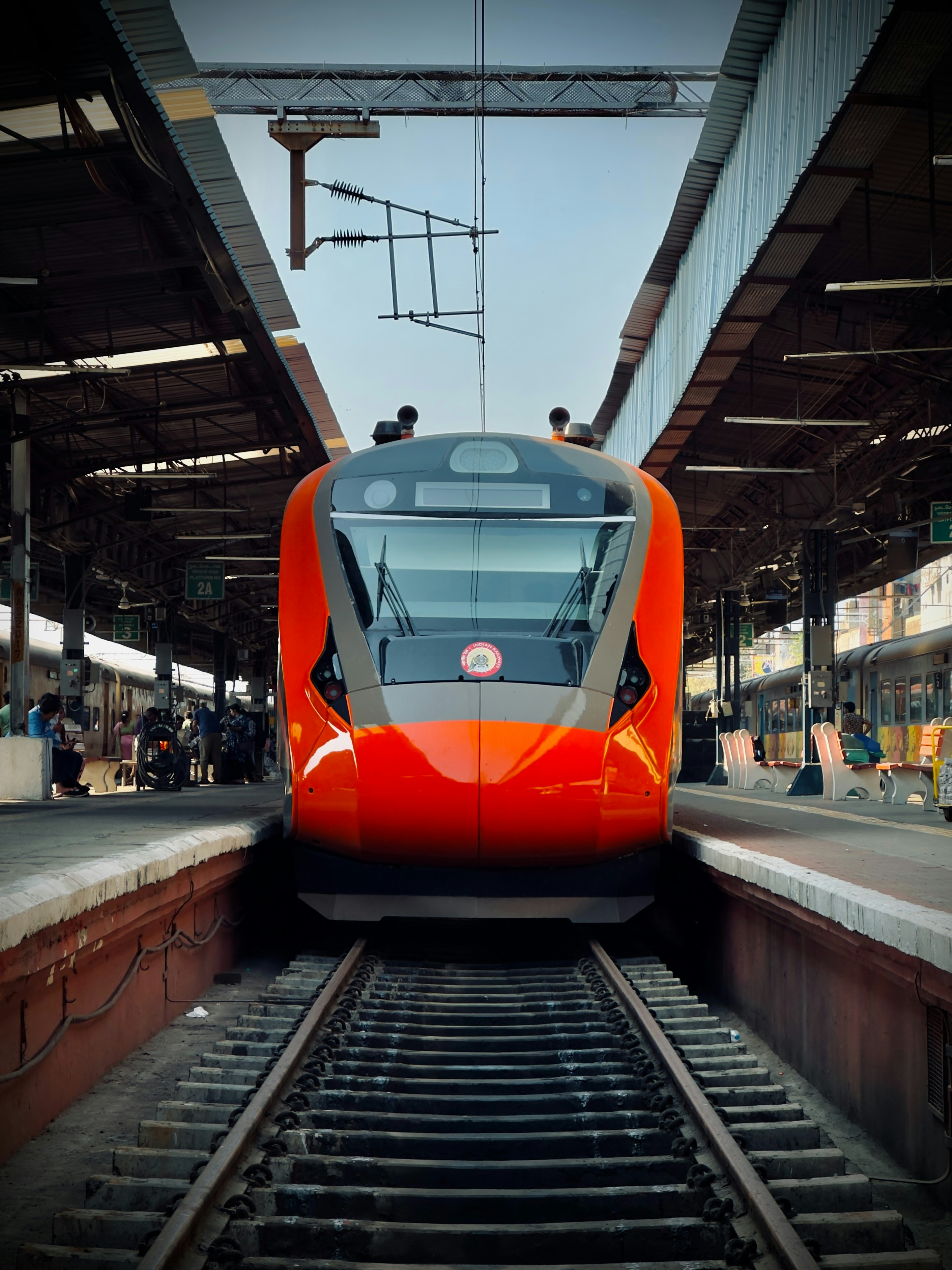 A red train is pulling into a train station photo – Free Chennai Image ...