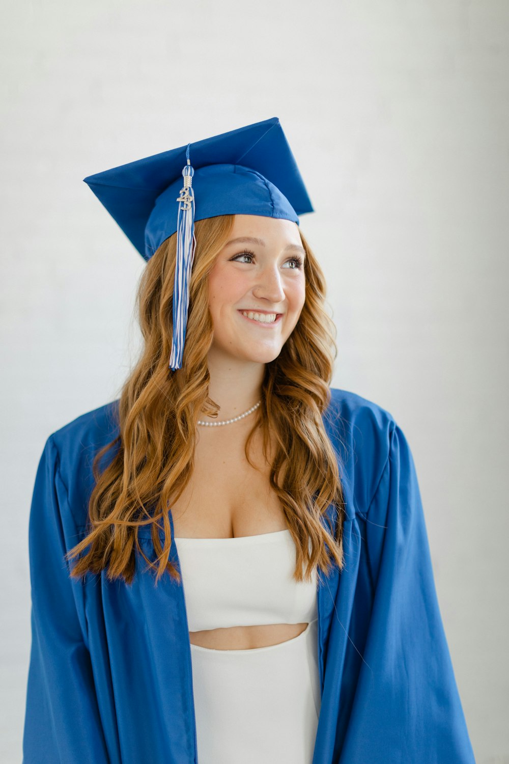 a woman in a blue graduation cap and gown