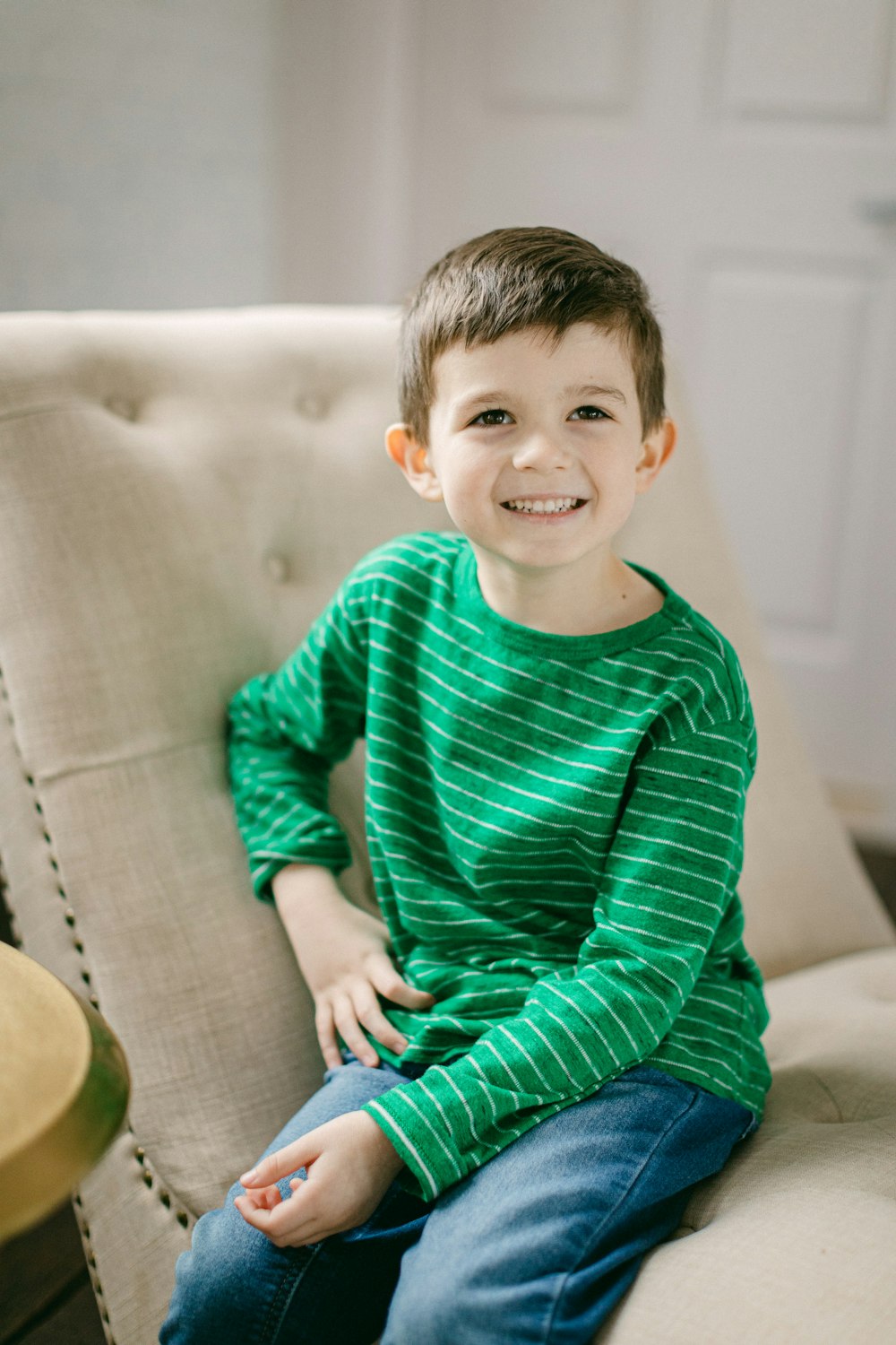 a young boy sitting on top of a couch
