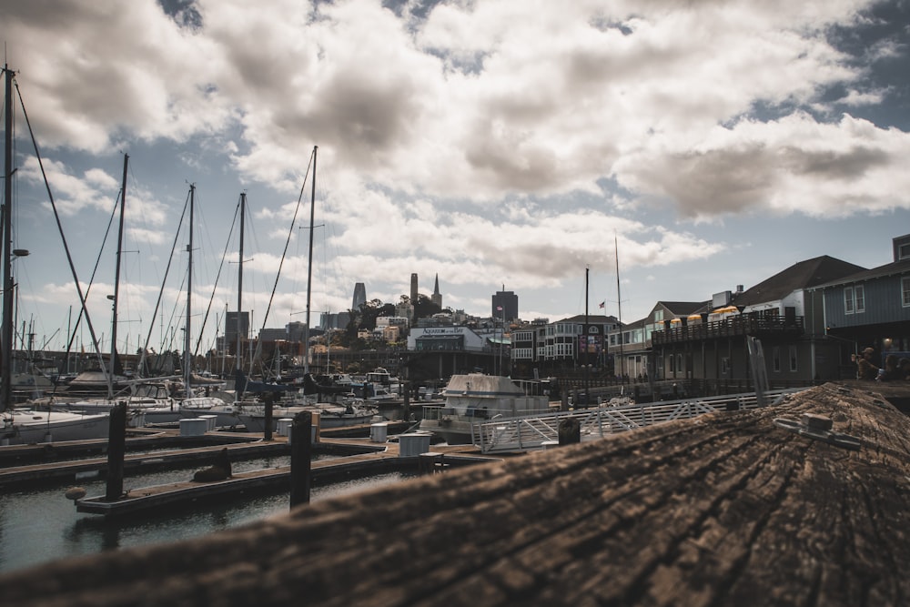 a harbor filled with lots of boats under a cloudy sky