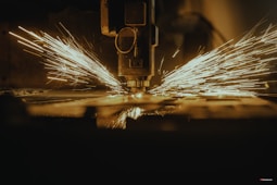 a piece of metal being cut with a machine