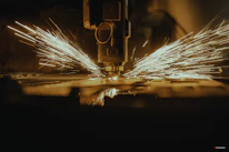 a piece of metal being cut with a machine