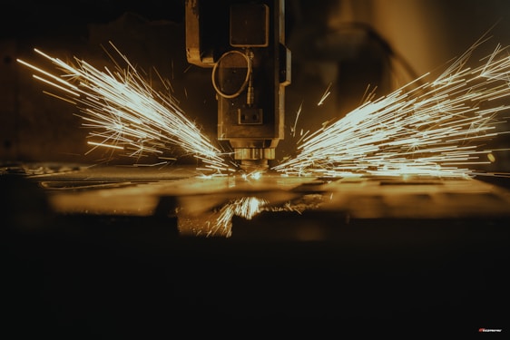 a piece of metal being cut with a machine