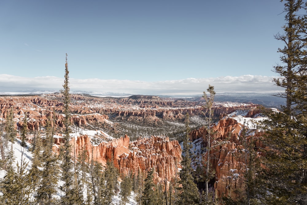 a scenic view of a mountain with snow on the ground