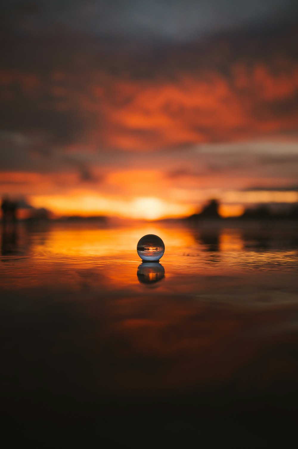 a blurry photo of a sunset with a rock in the foreground