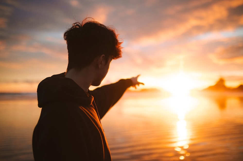 a person standing in front of a body of water