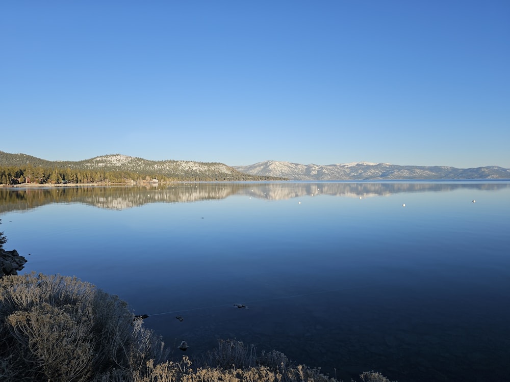 a large body of water with mountains in the background