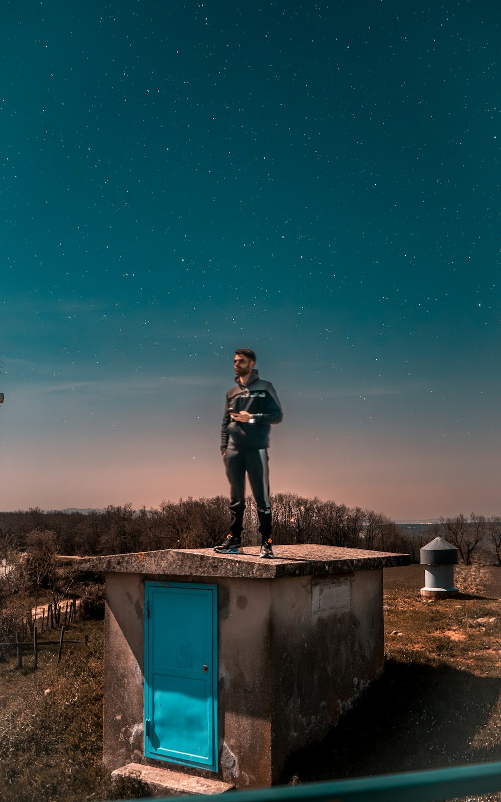 a man standing on top of a cement structure