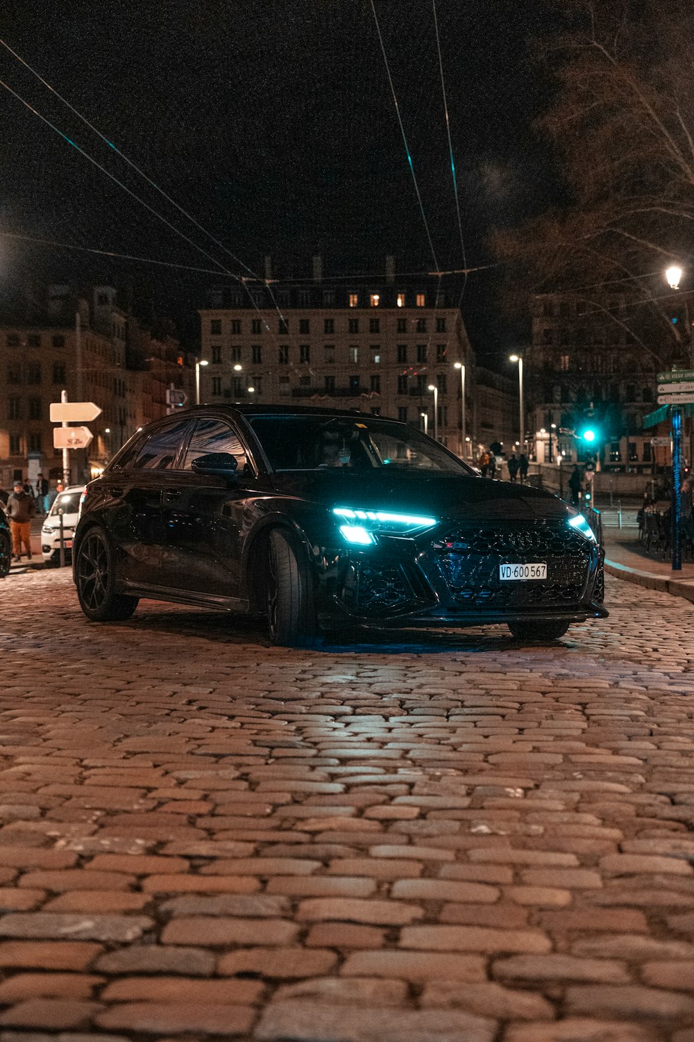 a black car parked on the side of the road