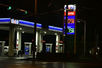 a gas station at night with the lights on