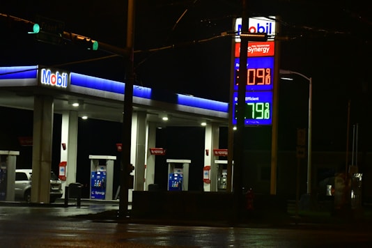 a gas station at night with the lights on