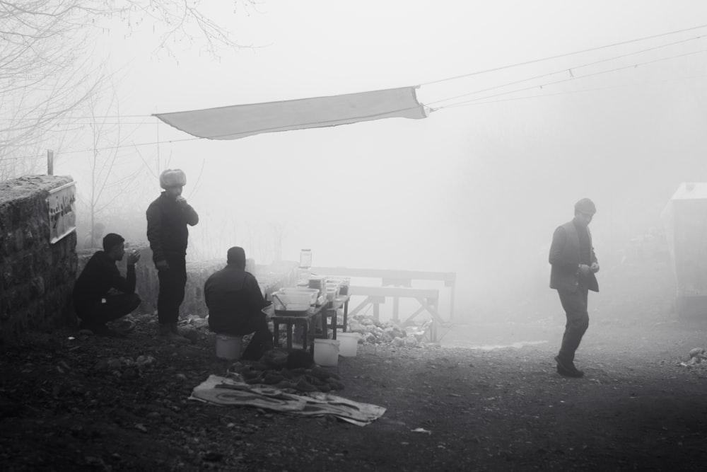 a group of people standing around in the fog