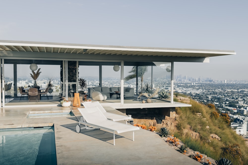 a modern house overlooking a city with a swimming pool