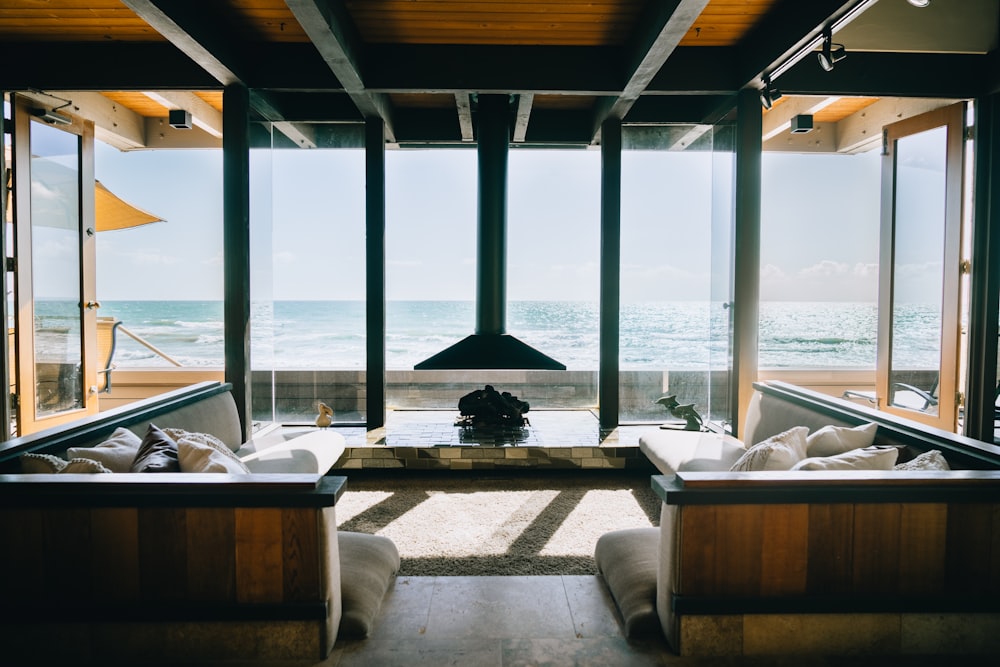 a living room filled with furniture next to a large window