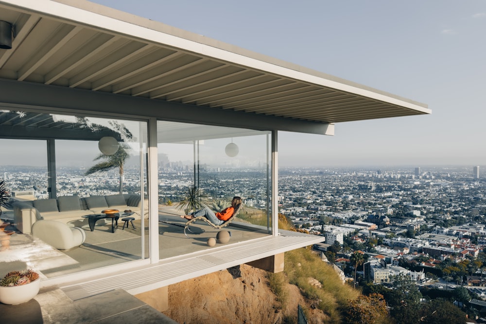 a person sitting on a balcony overlooking a city