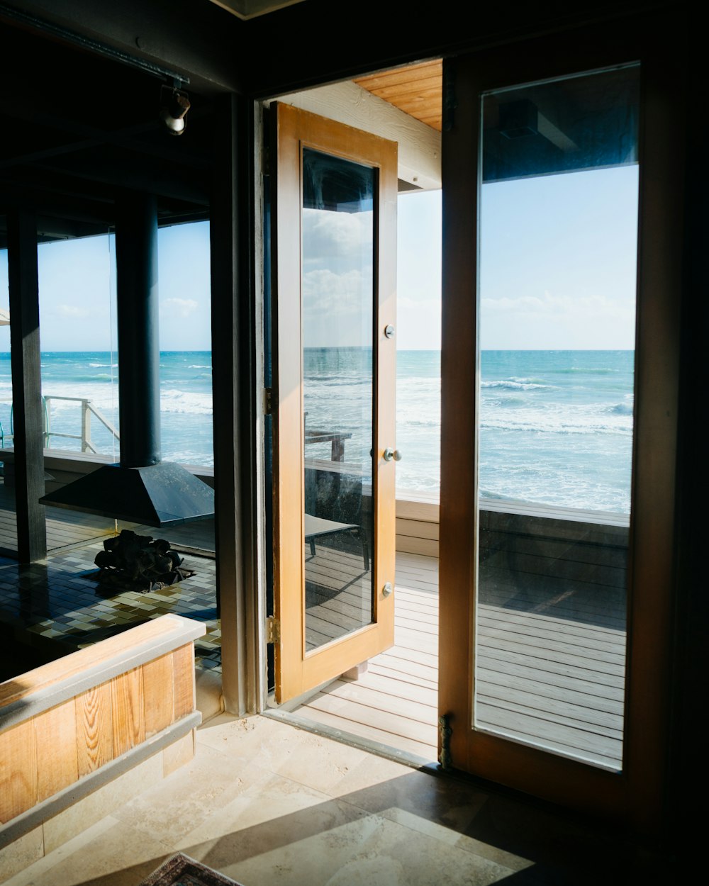 an open door leading to a balcony overlooking the ocean