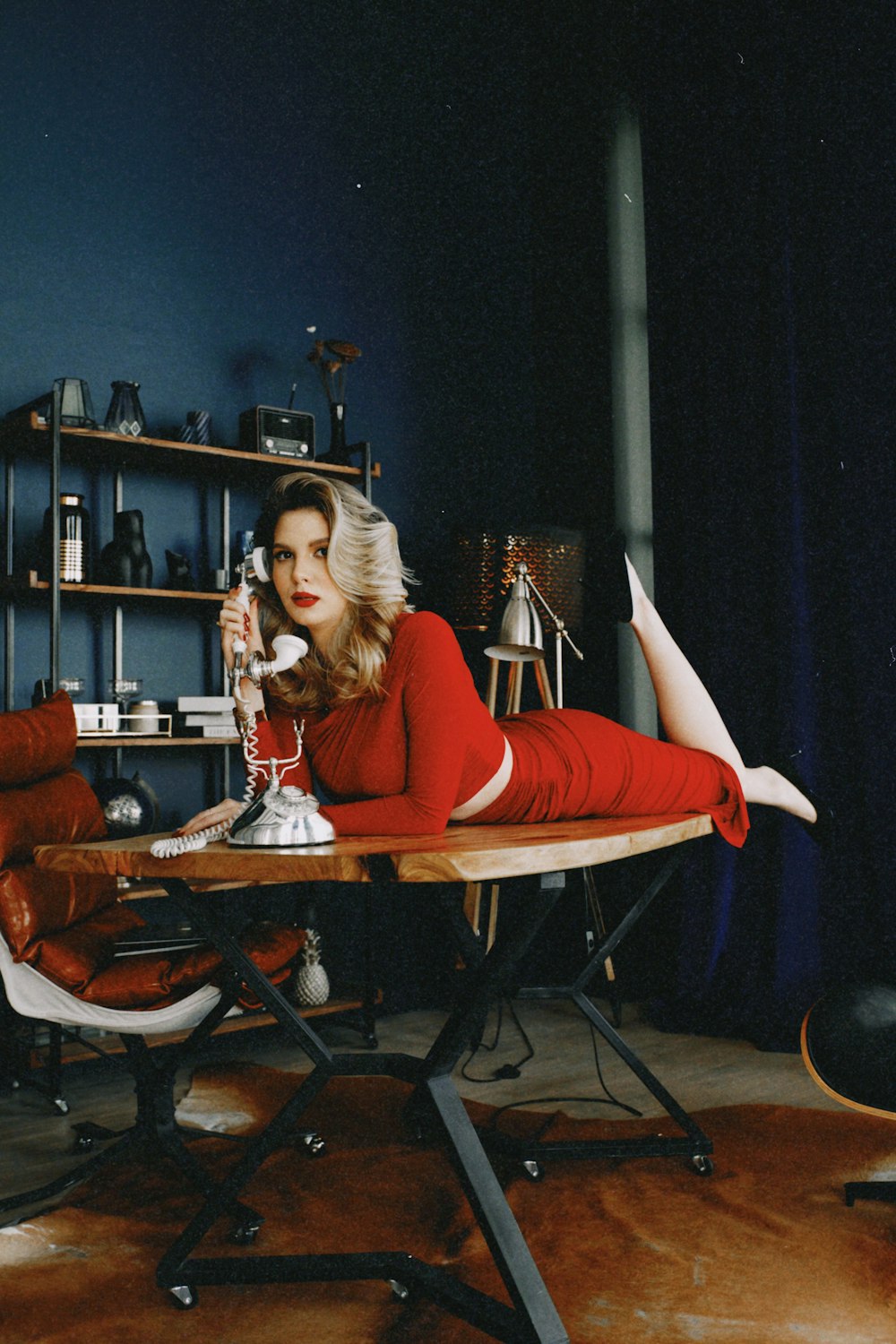a woman in a red dress sitting at a table