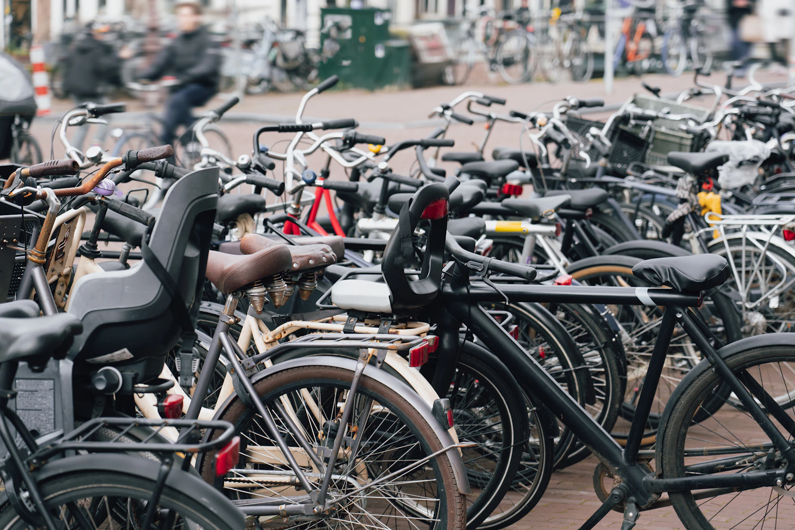 Rows of bicycles fill a Dutch station parking area