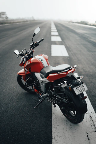 a red motorcycle parked on the side of the road