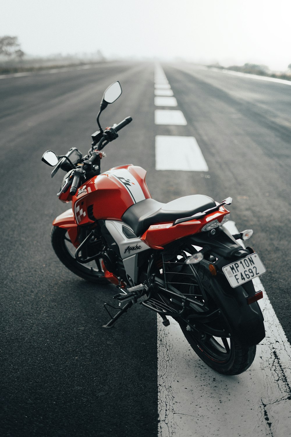 a red motorcycle parked on the side of the road