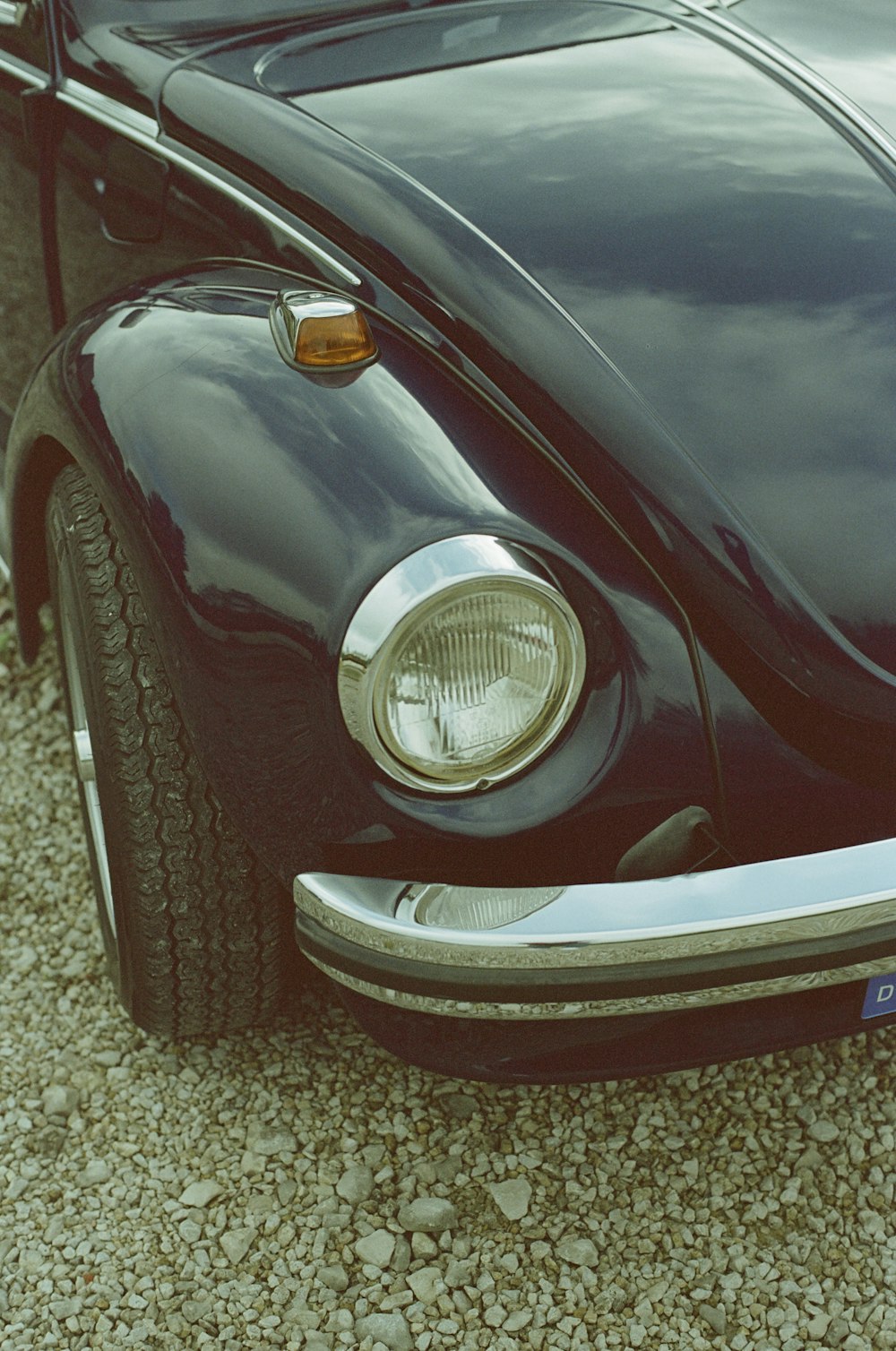 a close up of the front end of a black vw bug