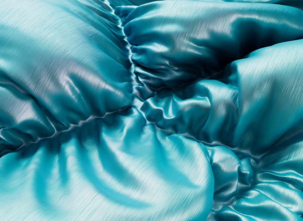 a close up view of a blue satin material