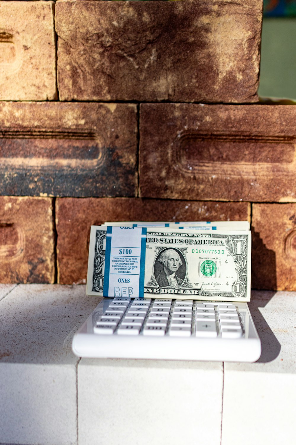a dollar bill sitting on top of a laptop keyboard